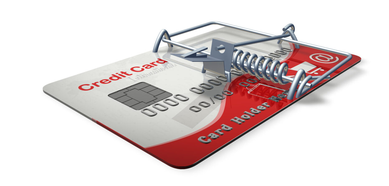 A graphic of a credit card with a mousetrap device on top.
