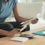 Cost of living income expense saving budget in black asia people Gen Z young adult woman. Looking credit card bill debt home loan money paying happy asian female healthy wealth care goal plan tracking