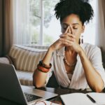 A stressed person at their laptop