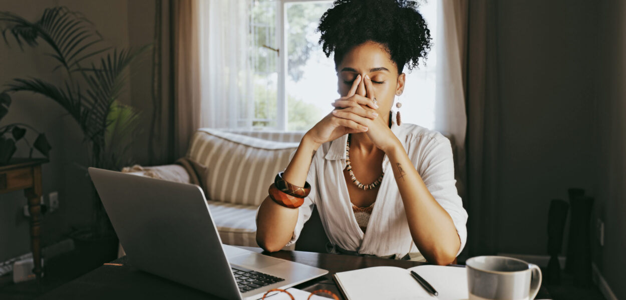 A stressed person at their laptop