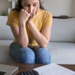 Concerned young woman reviewing finances