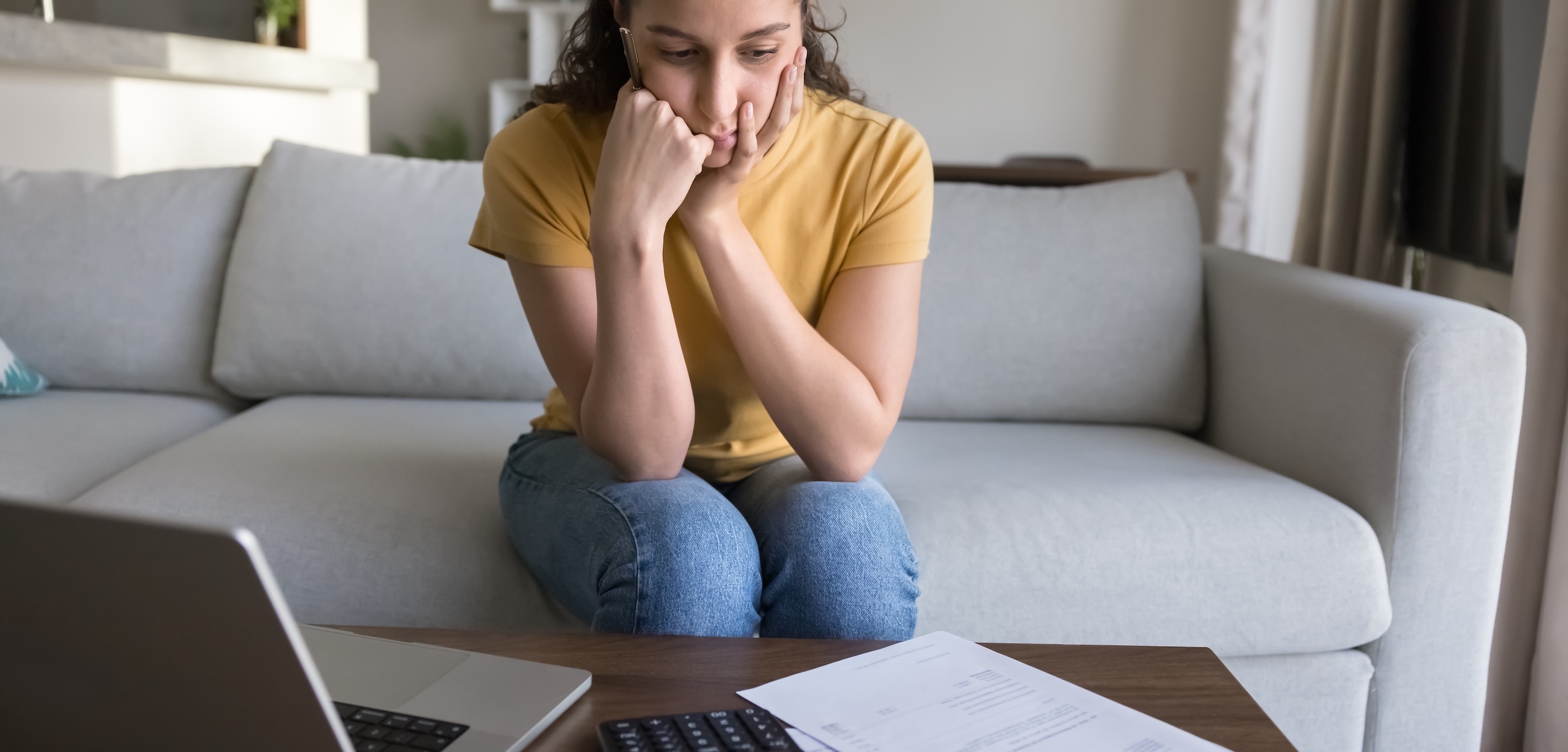 Concerned young woman reviewing finances