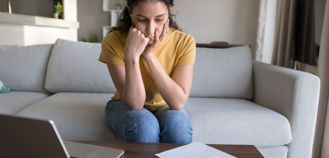 Concerned young woman reviewing finances